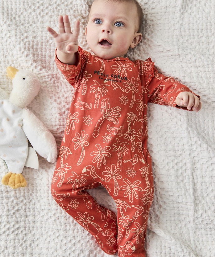 Newborn Tao Categories - baby sleeping bag in rust-colored organic cotton with palm tree and bird print